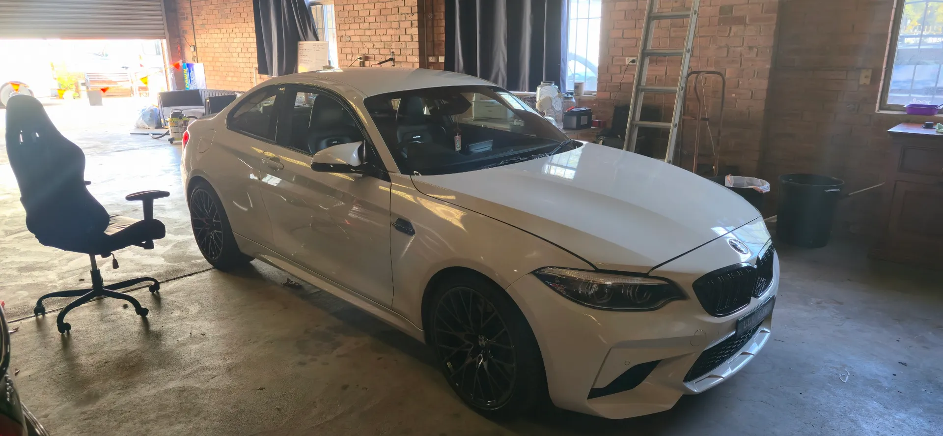 White BMW 318i front view in King of Pawn secure showroom