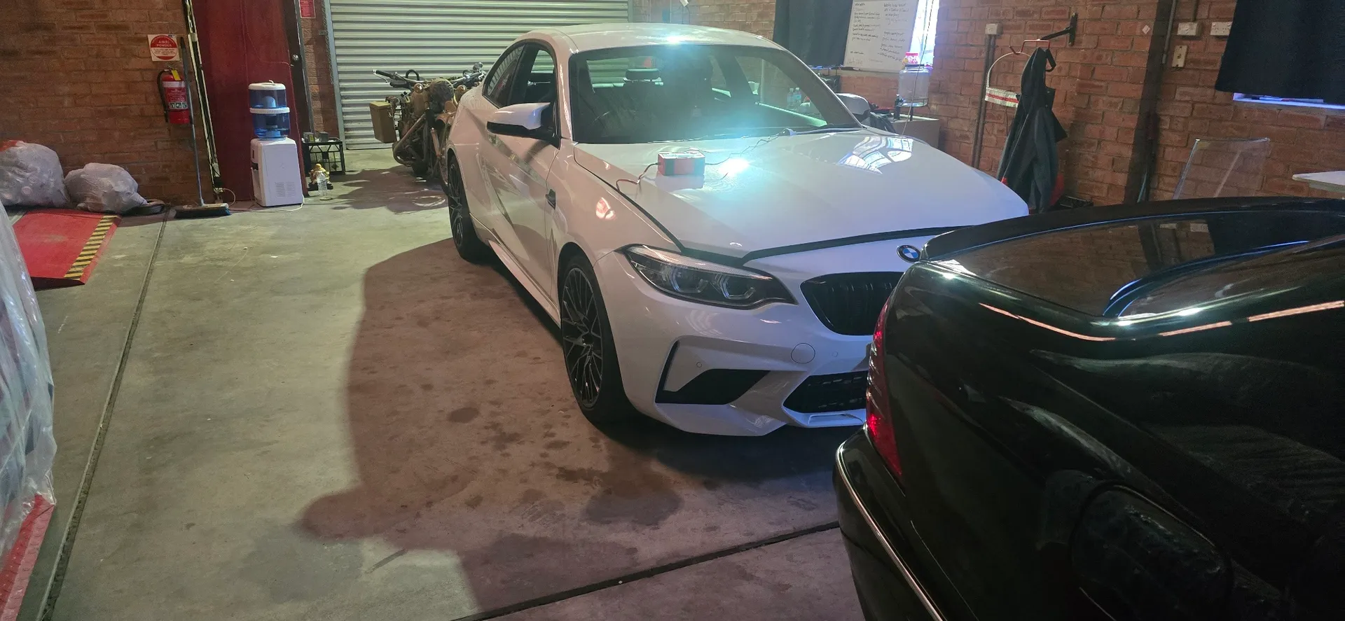 White BMW 318i side profile in climate-controlled storage